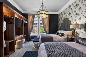a hotel room with two beds and a window at Clarence House in Derry Londonderry