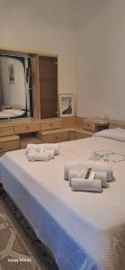 a bedroom with a large bed with towels on it at B&B Sa Rocca Manna in Laerru
