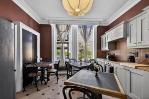 a kitchen with tables and chairs in a room at Clarence House in Derry Londonderry