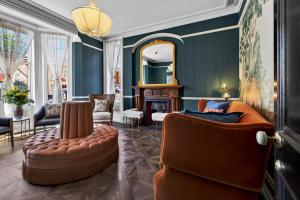 a living room with a couch and a mirror at Clarence House in Derry Londonderry