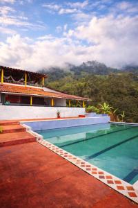 a swimming pool on the roof of a house at Finca la pilarica in Istmina