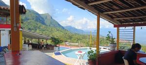 a swimming pool with a view of a mountain at Finca la pilarica in Istmina