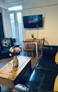 a living room with a couch and a coffee table at Harrington House - Perfect for contractors Sleeps 15 in Workington