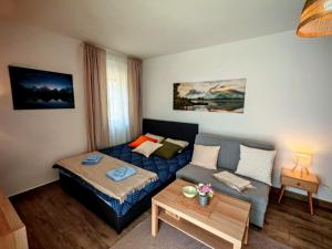 a living room with a bed and a couch at Studio Vidik Sofija in Divčibare
