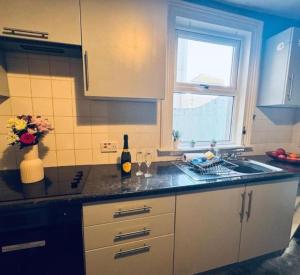 a kitchen counter with a sink and a window at Harrington House - Perfect for contractors Sleeps 15 in Workington +5 photos