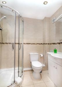 a bathroom with a toilet and a shower and a sink at The Clubhouse in Sheffield +45 photos