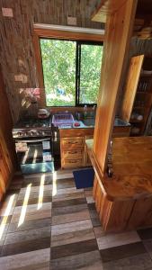 a kitchen in a log cabin with a stove at Lanco in Lanco +4 photos