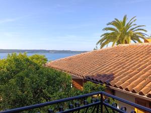 a view of a house with a tile roof at Apartments & Rooms Karmen in Portorož