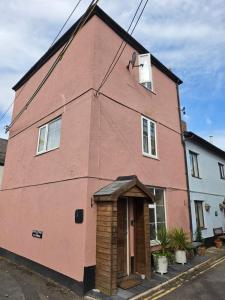 a red brick building with a small door at Lighthouse cottage in Watchet