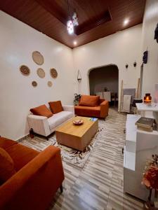 a living room with two couches and a coffee table at Amber Home Kigali in Kigali