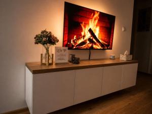 a fireplace on a wall with a fire in it at Sara Luxe Family in Konjic