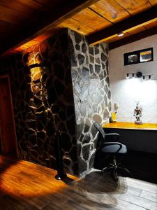 a office with a chair and a stone wall at Mazamitla Pinos del Rio in Mazamitla +285 photos