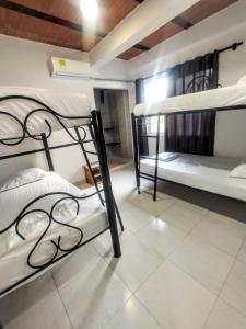 a bedroom with two bunk beds in a room at Hotel Coralite Suites Santa Marta in Santa Marta +37 photos