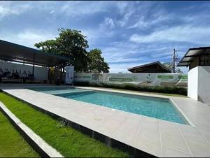 a swimming pool in the yard of a house at Bayanihan flats Condo in Pajak