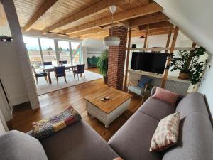 a living room with a couch and a table at Öko Wohnung Garten und Pool in Lindau-Bodolz