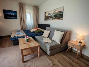 a living room with a couch and a bed at Studio Vidik Sofija in Divčibare