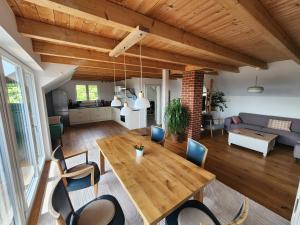 a living room with a wooden table and chairs at Öko Wohnung Garten und Pool in Lindau-Bodolz