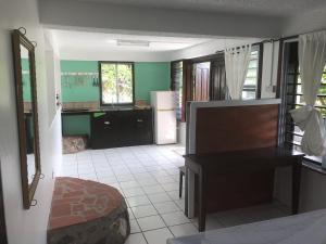 a living room with a kitchen with a table and a desk at La Panache Guesthouse in Gros Islet +14 photos