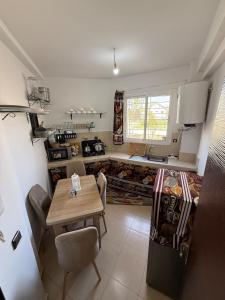 a kitchen with a table and chairs in a room at Dar Ifrane in Ifrane