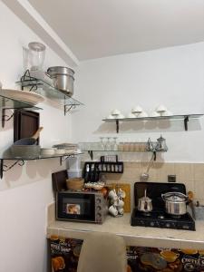 a kitchen with a stove and some pots and pans at Dar Ifrane in Ifrane +7 photos
