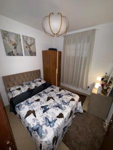 a bedroom with a bed and a chandelier at Dar Ifrane in Ifrane