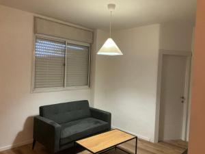 a living room with a couch and a table at דירת בוטיק מפנקת in Beer Sheva