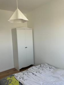 a bedroom with a white cabinet and a bed at דירת בוטיק מפנקת in Beer Sheva