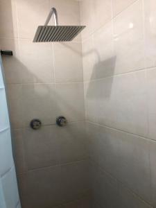 a shower with a shower head in a bathroom at La Panache Guesthouse in Gros Islet