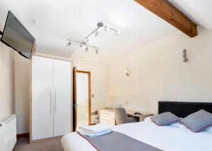 a bedroom with a bed and a desk and a television at The Clubhouse in Sheffield