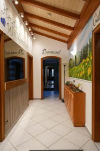 a corridor of a building with a entrance to a pharmacy at Waldhotel Einstein in Kirchhundem