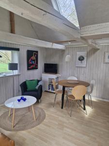 a living room with two tables and a couch at Hyttan in Åkirkeby