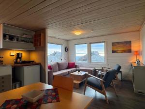 a living room with a couch and a table at Sandhåland Camping Hytte nr 7 in Sandhåland +19 photos