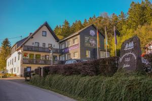 a building with a sign in front of it at Waldhotel Einstein in Kirchhundem