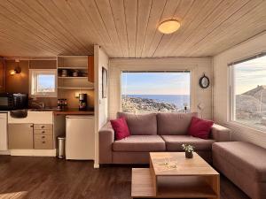 a living room with a couch and a table at Sandhåland Camping Hytte nr 7 in Sandhåland