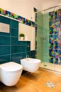 a bathroom with a toilet and a glass shower at Central Dorgali Guest House in Dorgali +61 photos