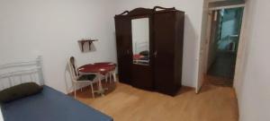 a room with a cabinet and a table and a chair at Mycoffee Apartment in Mindelo