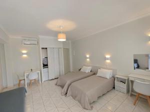 a bedroom with a bed and a table and chairs at Aktio Studios in Gavrio +11 photos
