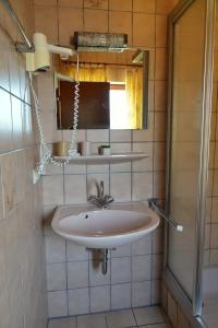 a bathroom with a sink and a mirror at Waldhotel Einstein in Kirchhundem +175 photos