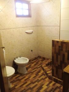 a bathroom with a toilet and a sink at Cabañas Kay Hue in San Carlos de Bariloche