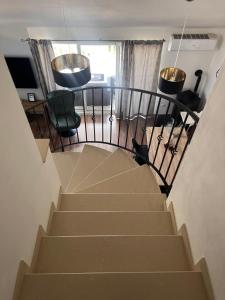 a staircase leading to a room with a table and chairs at Luxury apartment Duće with private pool in Omiš