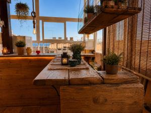 a wooden table in a room with a window at Suites Sangiovanni in Ragusa +63 photos