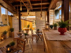 a large room with tables and chairs and windows at Suites Sangiovanni in Ragusa
