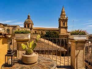 a view of a building with a clock tower at Suites Sangiovanni in Ragusa