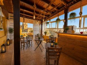 a patio with tables and chairs in a building at Suites Sangiovanni in Ragusa