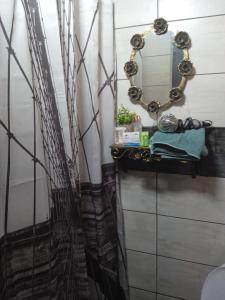a bathroom with a mirror and a sink at Vikendica Dunav i SAVA in Donji Milanovac +31 photos