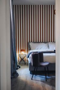 a bedroom with a bed and a chair in it at Portico Provenzali in Cento