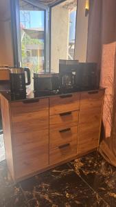a wooden dresser with two microwaves on top of it at My Wellness Ferienwohnung in Bullay