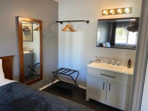 a bathroom with a sink and a mirror at Monashee Lodge in Revelstoke +36 photos