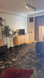 a room with a table and a tv in it at My Wellness Ferienwohnung in Bullay