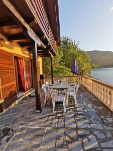 a patio with a table and chairs on a house at Vintage house Jablanica Lake in Železnička Stanica Jablanica Grad